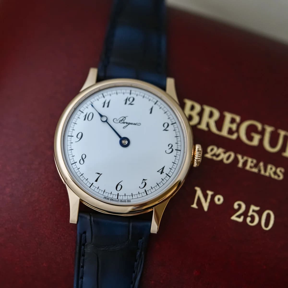 Bezel edge detail showing the polished dome, case proportions, and the subtle warmth of the Breguet gold alloy