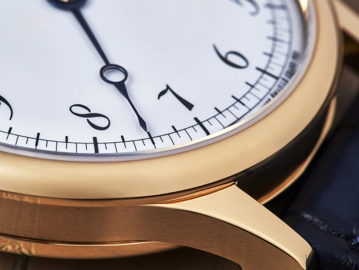 Caseback macro showing the Quai de l'Horloge guilloche pattern, balance wheel with Nivachron spring, and blued steel screws