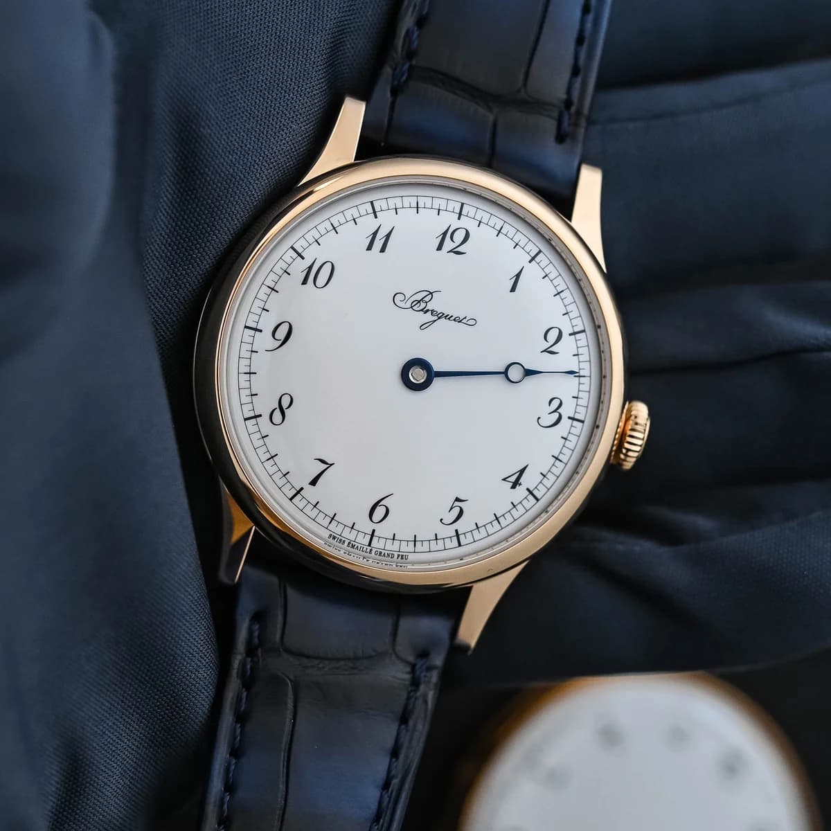 Side profile revealing the satin-brushed flanks, signed crown with Breguet monogram, and 10.8mm case height
