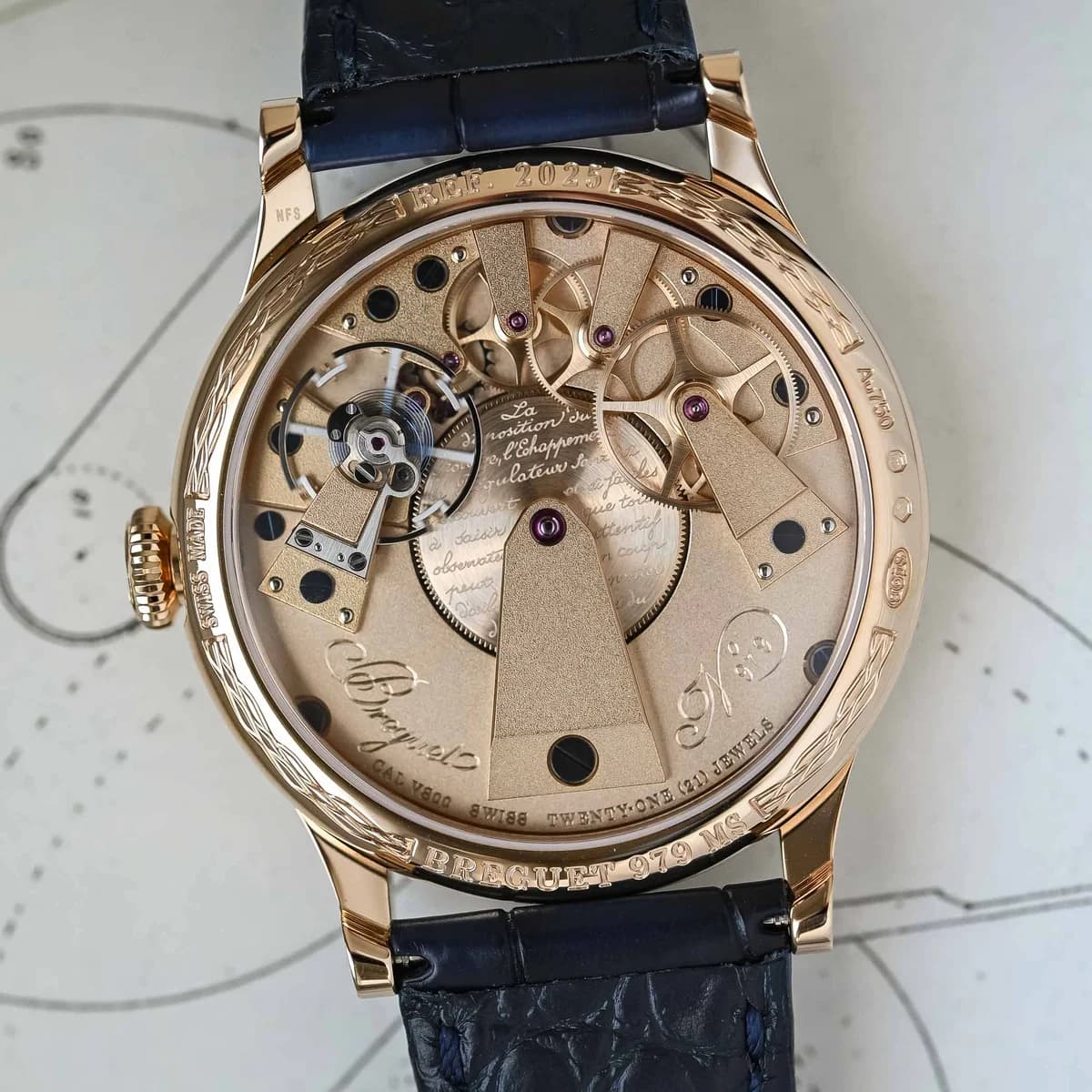 Side view highlighting the flat knurled crown, satin case flanks, and the transition between polished bezel and brushed sides