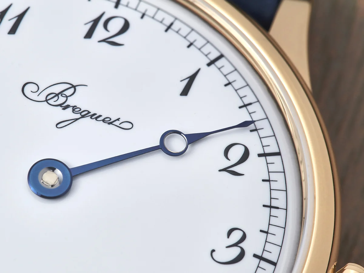 The watch on navy fabric, showing the alligator strap texture and Grand Feu enamel dial with chemin de fer minute track