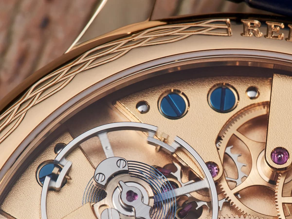 The Caliber VS00 visible through the sapphire caseback, showing the symmetrical bridge layout and hand-engraved ratchet wheel