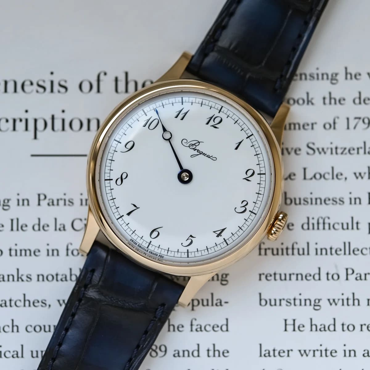 The Breguet Classique Souscription 2025, tight crop on the white Grand Feu enamel dial with single flame-blued pomme hand