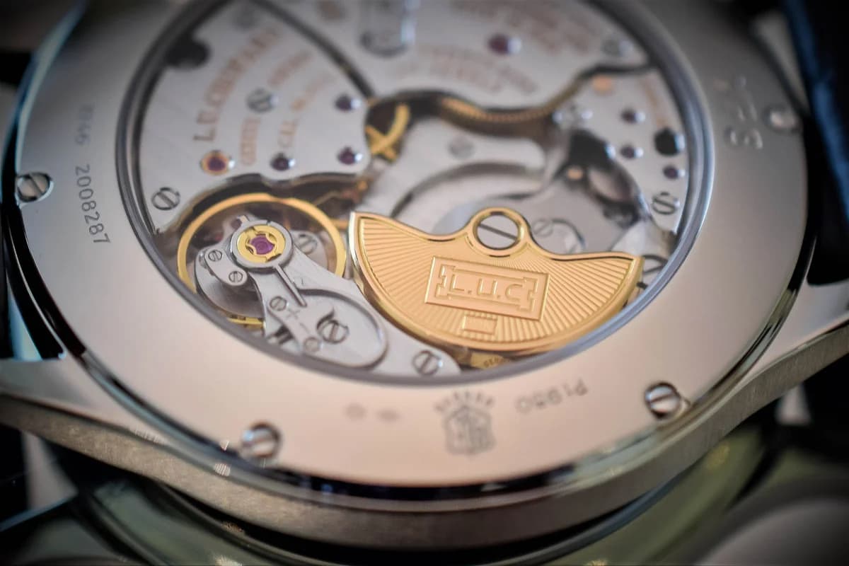 Close-up of the white gold bezel, blue-grey sunburst dial, and applied rhodium-plated indices with crown at 4 o'clock