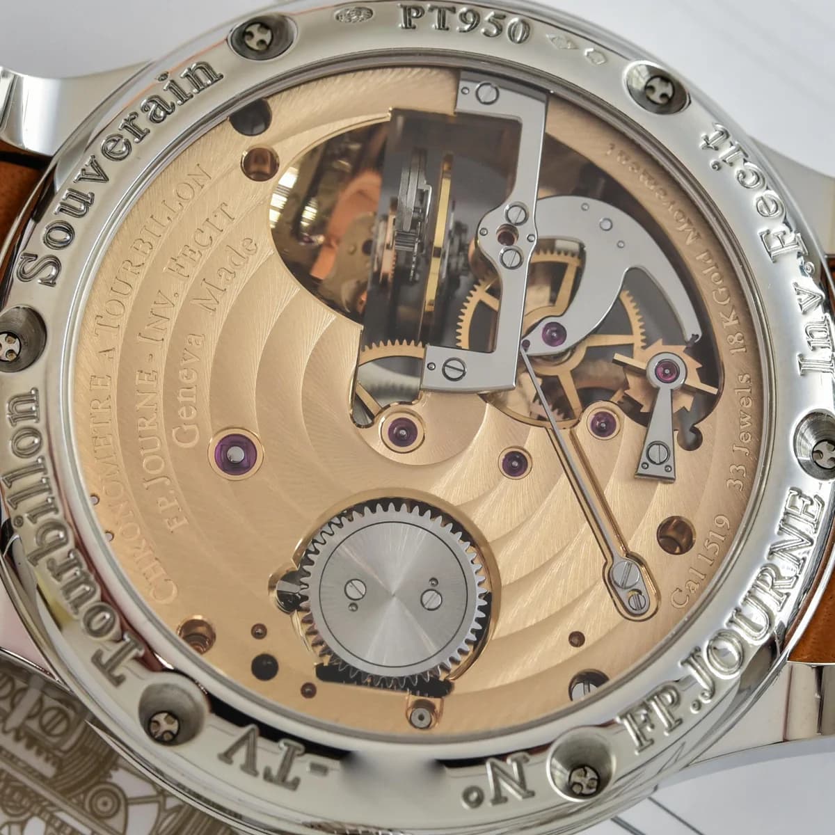 Macro detail of the horizontal tourbillon cage visible through the dial aperture, Caliber 1403