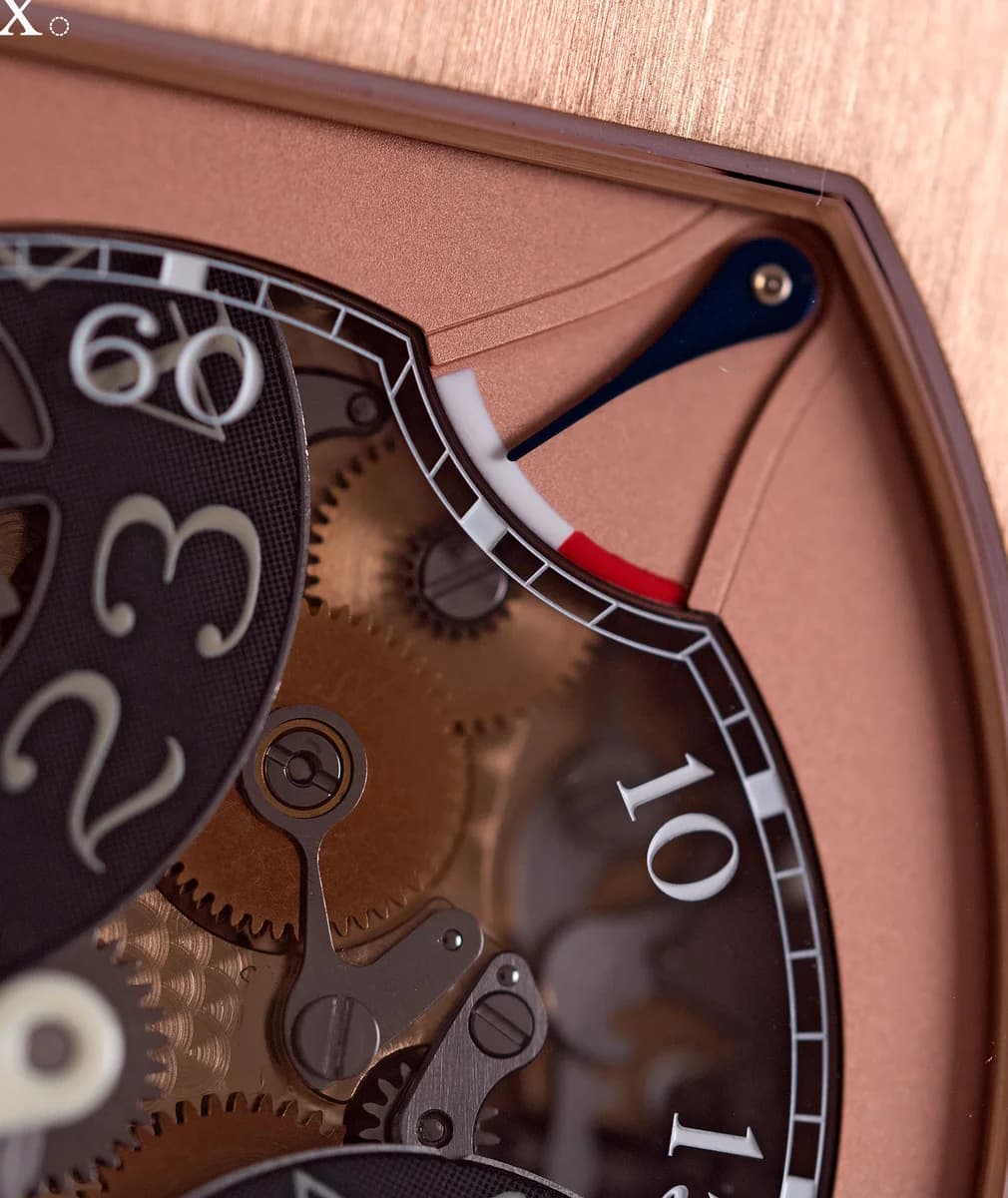 Dial macro showing the jumping seconds discs, minute hand, and rose gold movement visible through smoked sapphire