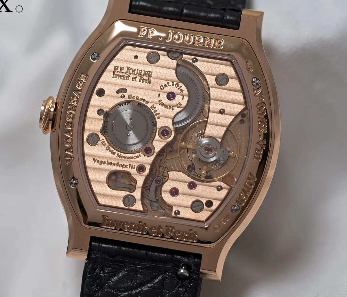 Movement macro showing the Caliber 1514 balance wheel, Geneva stripes, and barrel through the rose gold caseback
