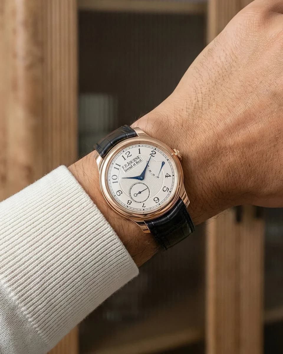 Close-up of the rose gold movement showing the barrel bridge and the chamfered edges on the bridges.