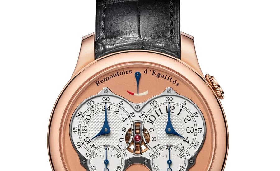Movement macro of the Caliber 1520 showing the twin balance wheels, rose gold bridges with Geneva stripes, and the central differential mechanism that allows both gear trains to share a single mainspring.