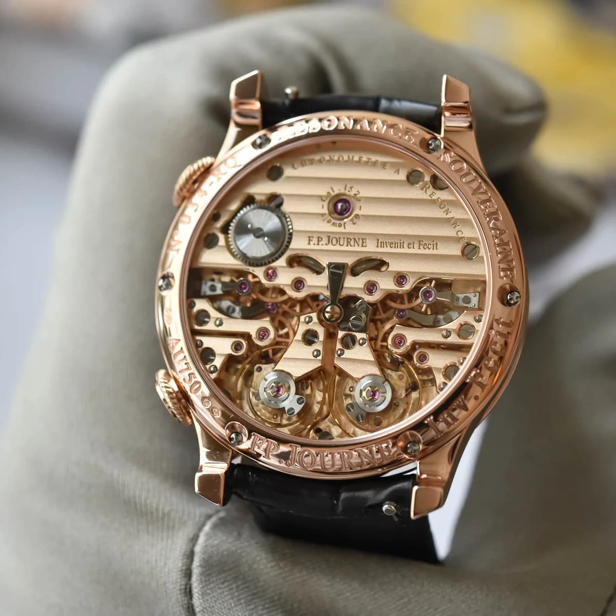 Rose gold caseback showing the Caliber 1520 movement. 62 jewels, Geneva stripes on the bridges, and the dual balance wheels visible at the bottom of the movement.