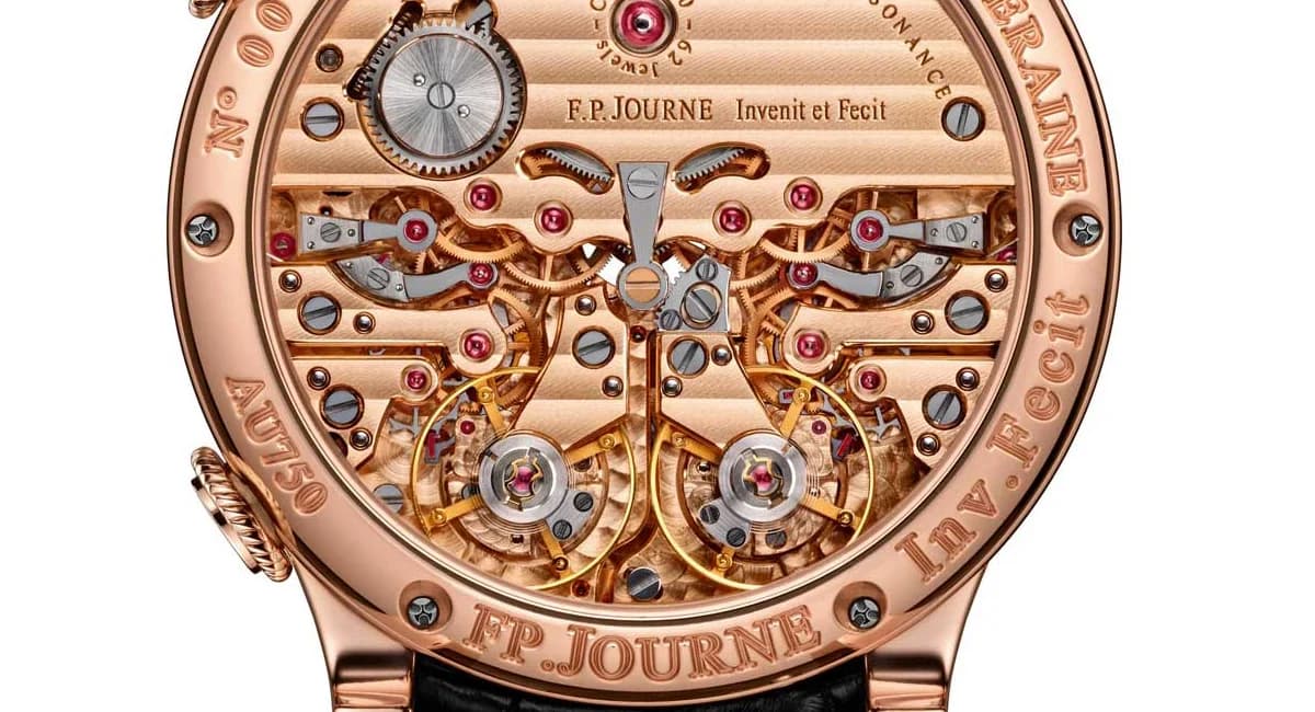 The Caliber 1520 in rose gold, photographed through the sapphire caseback. Twin balance wheels at 7 and 5 o'clock, Geneva striped bridges, and the engraved Invenit et Fecit inscription.