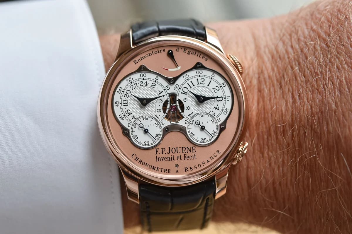 Three-quarter view of the rose gold Resonance showing the case profile, twin crowns at 2 and 4 o'clock, and the warm 6N gold dial against white silver subdials.