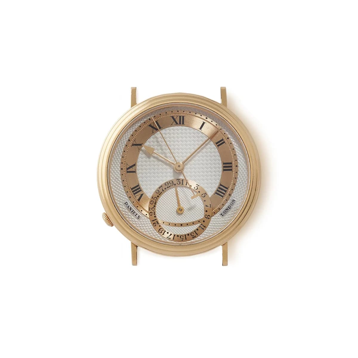 Dial macro showing the barleycorn guilloche pattern, engraved Roman numerals on the gold chapter ring, and the date subdial with Arabic numerals.