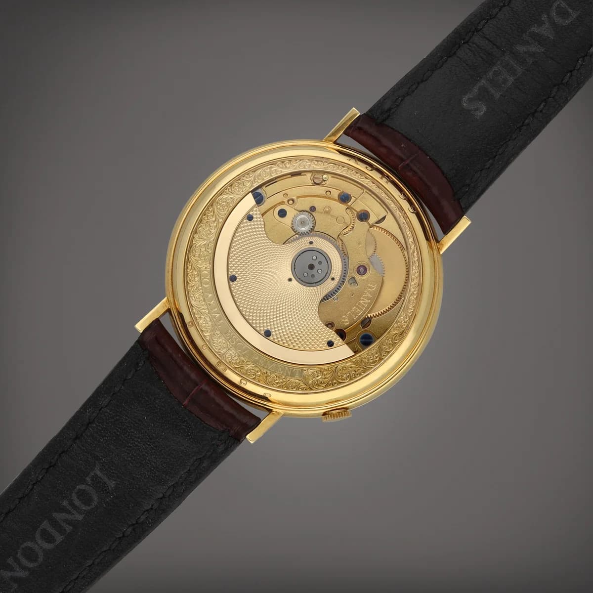 The Millennium on wrist with a brown crocodile strap, showing how the 37mm case wears with a suit cuff.