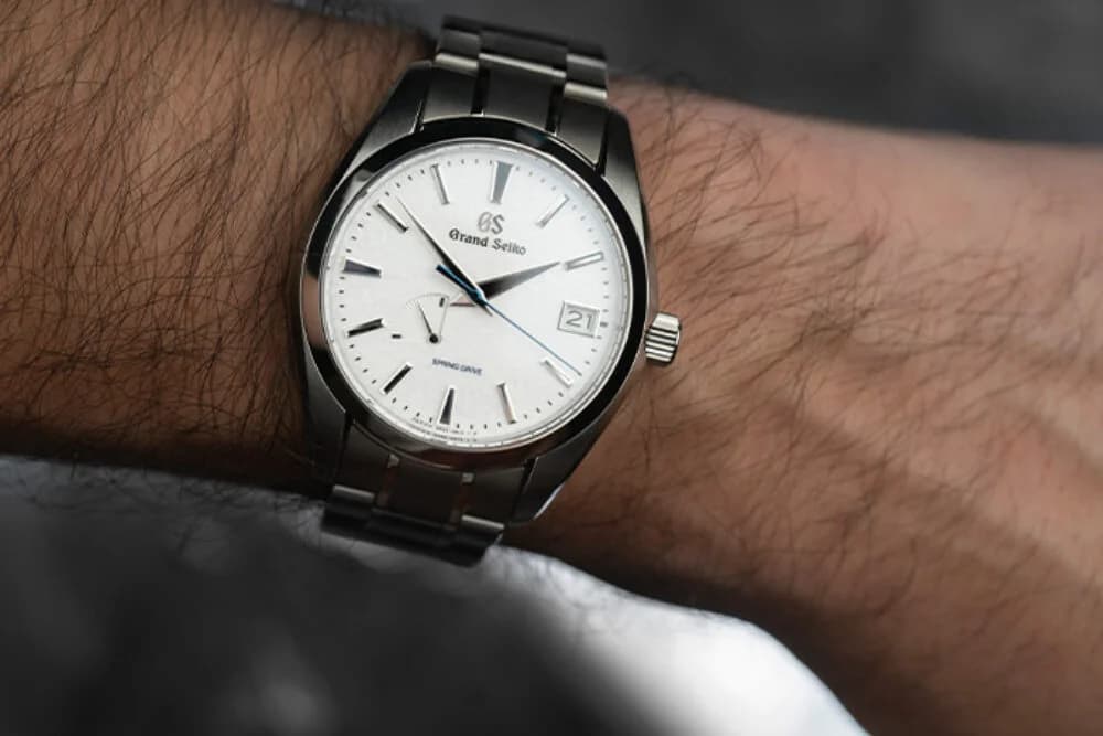 Low-angle view showing the Snowflake dial, GS-branded crown, and case profile from below