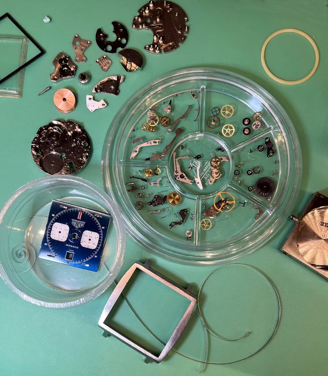 The Caliber 11 movement with "HEUER CAL.11" and "SEVENTEEN 17 JEWELS" engravings visible. The modular construction combining Buren base and Dubois-Depraz chronograph module.