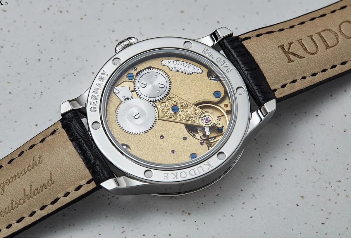 The fluted onion crown detail, a period-correct touch connecting to the English pocket watch aesthetic