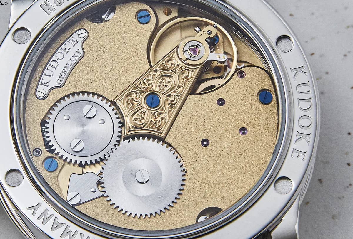 Exhibition caseback revealing the Kaliber 1-24H with frosted gilt bridges, hand-engraved balance cock, and blued screws