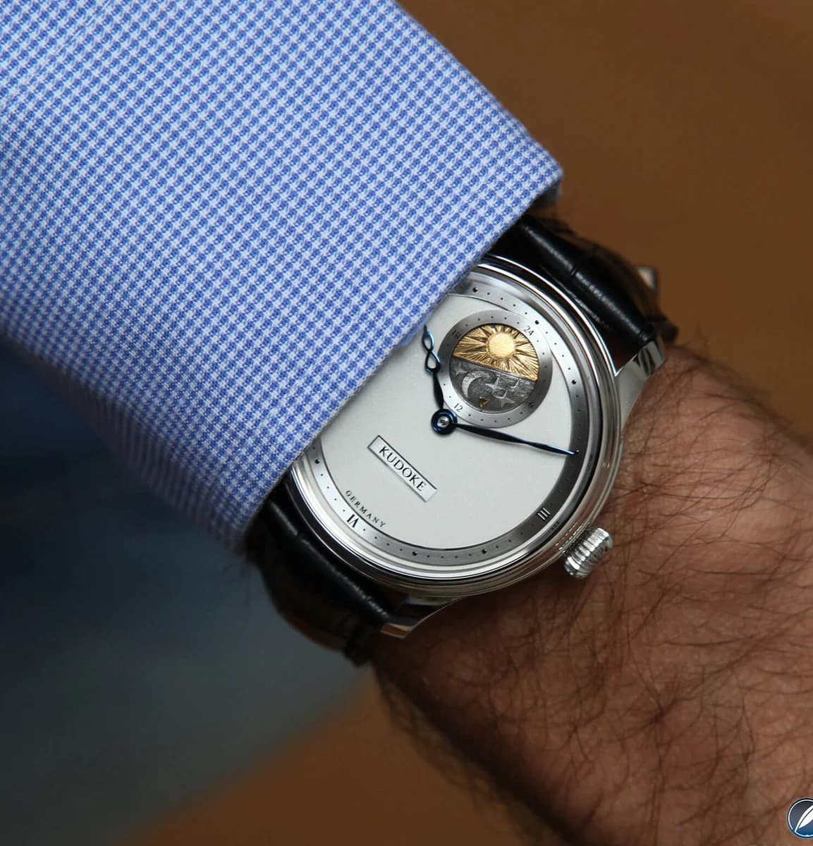 Low angle revealing the case profile, stepped bezel, and 10.7mm thickness