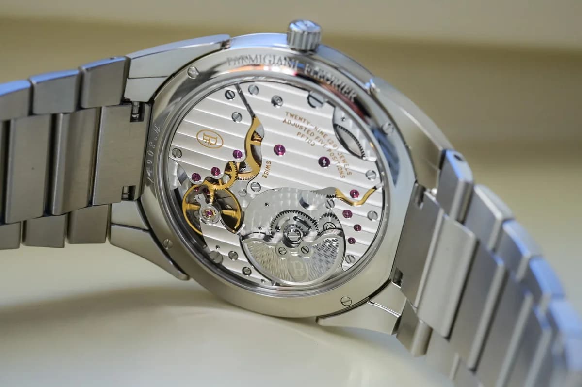 Exhibition caseback showing the Caliber PF703 with Cotes de Geneve stripes, 29 jewels, and 950 platinum micro-rotor