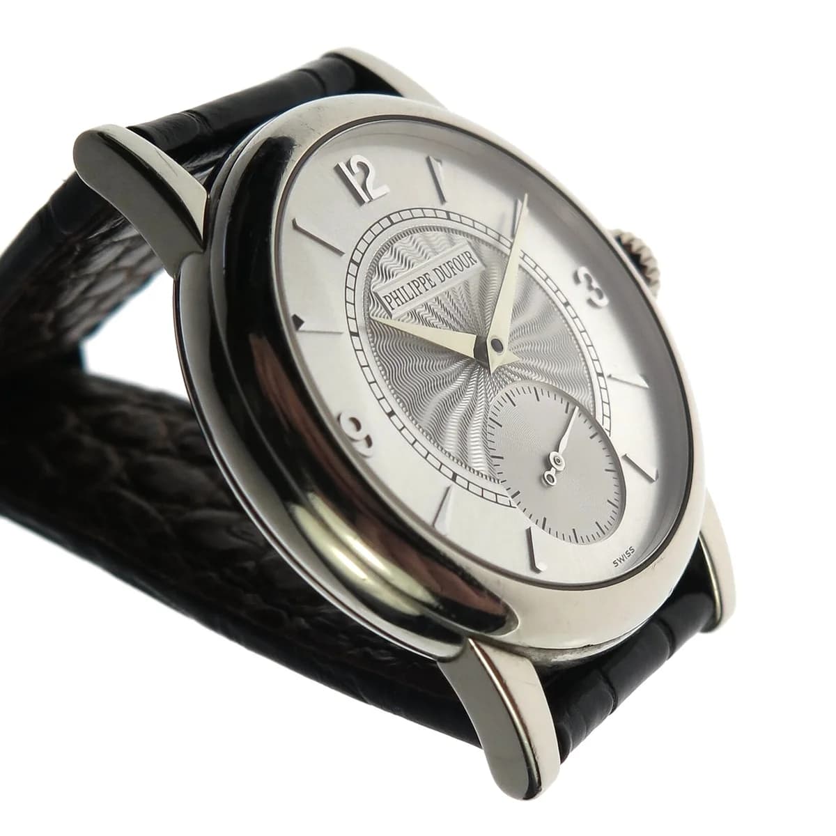 Philippe Dufour Simplicity, guilloche dial variant in white gold. Arabic numerals at 12, 3, and 9 with applied indices.