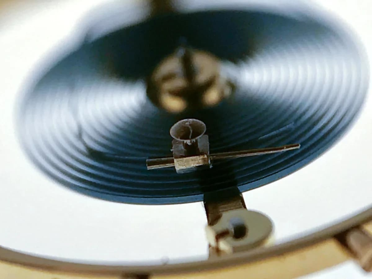 Crown and case angle showing the Breguet hands, white lacquer dial with Roman numerals, and Metalem signature at six o'clock.