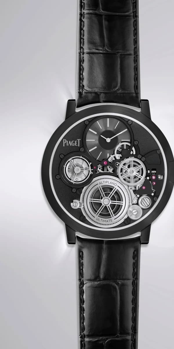 The AUC on its curved profile. At 23 grams with strap, it weighs less than a handful of coins.