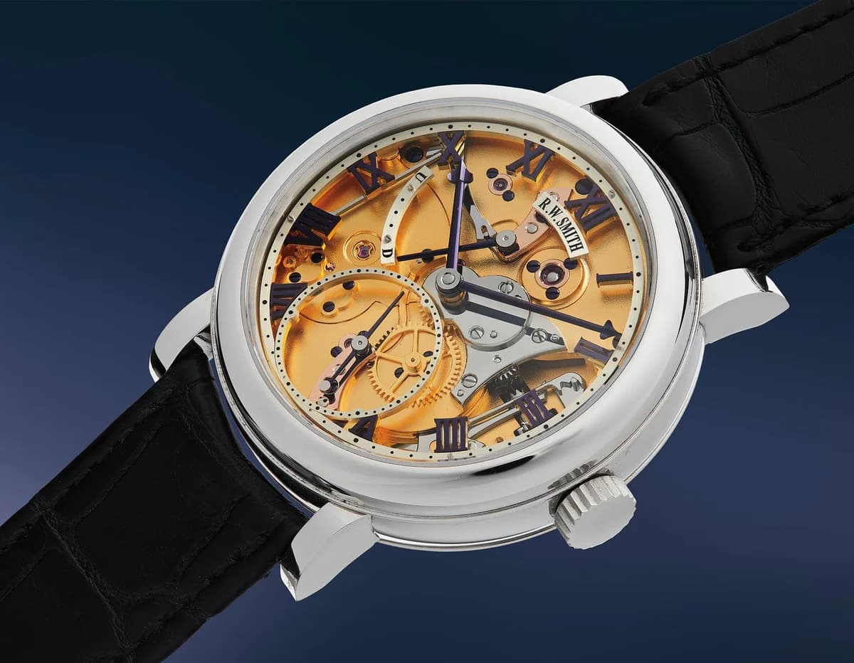 Roger Smith Series 2 in stainless steel. Engine-turned silver dial with blue Roman numerals, subsidiary seconds at six, and power reserve indicator at ten o'clock.