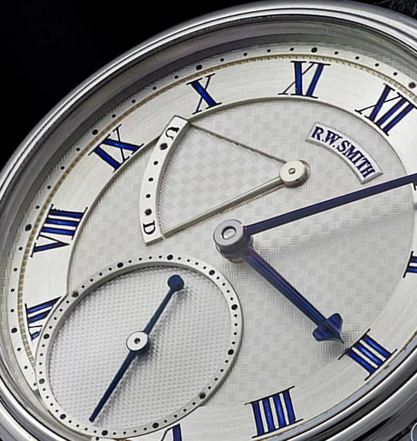 Series 2 bespoke commission in 18K gold with hand-engraved silver dial. The crown at three o'clock and the distinctive stubby lugs are characteristic of Smith's early case design.