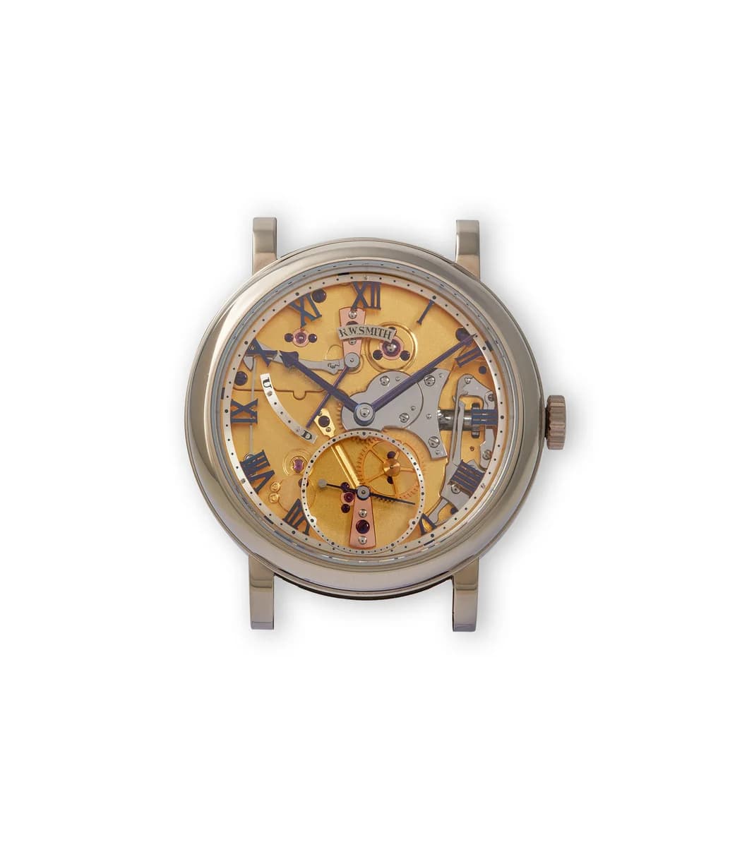 Dial macro showing the engine-turned silver surface, blue Roman numerals, and the sector power reserve indicator. The hand-finishing on the indices and hands is visible under magnification.