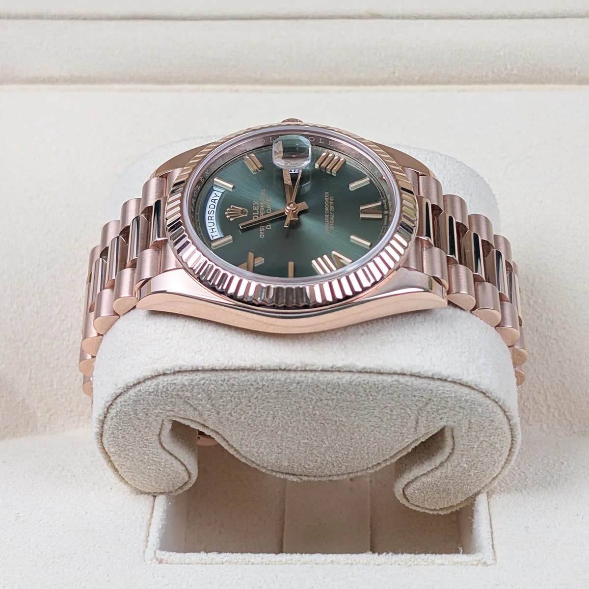 Crown side view showing the olive green dial shifting color under angled light.