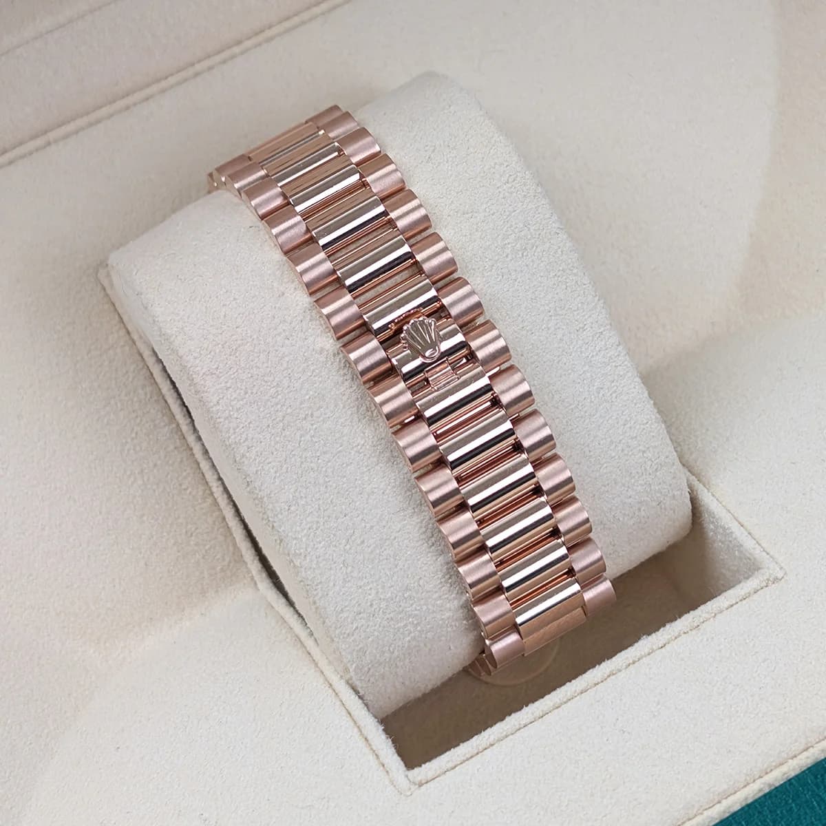 The President bracelet on green leather, showing the semi-circular three-piece link design and solid caseback.