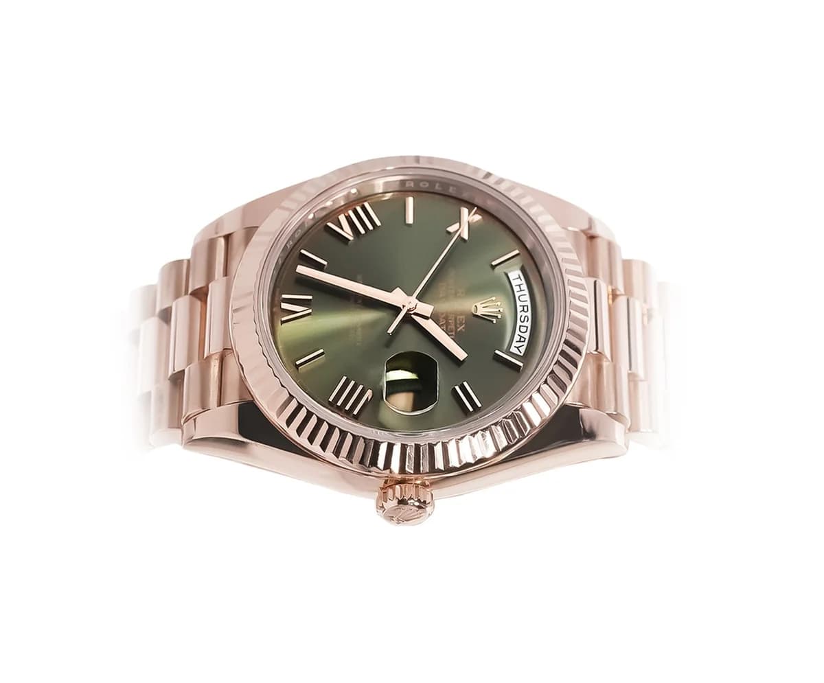 Three-quarter view showing the fluted bezel refracting light and the President bracelet's semi-circular links.