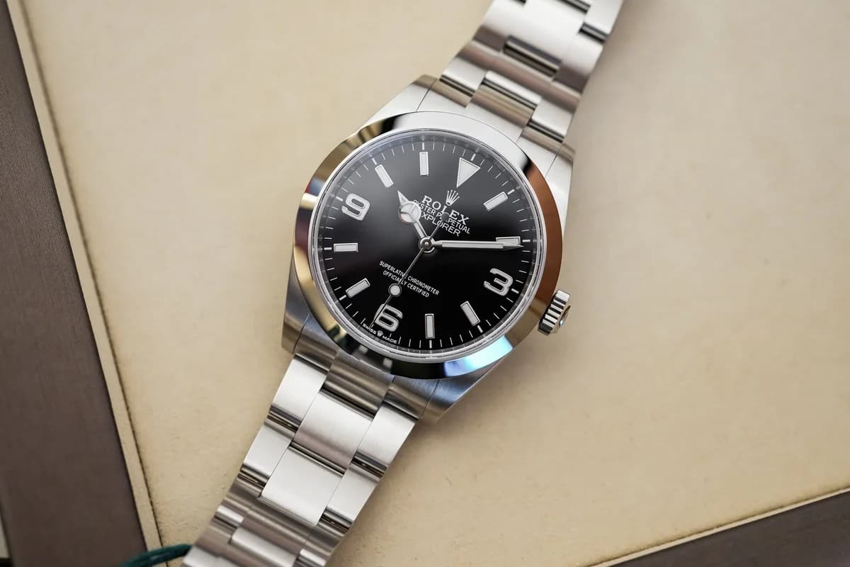 The smooth polished bezel catching light at an angle. No markings, no insert, no scale. The bezel-to-crystal transition is clean and deliberate.