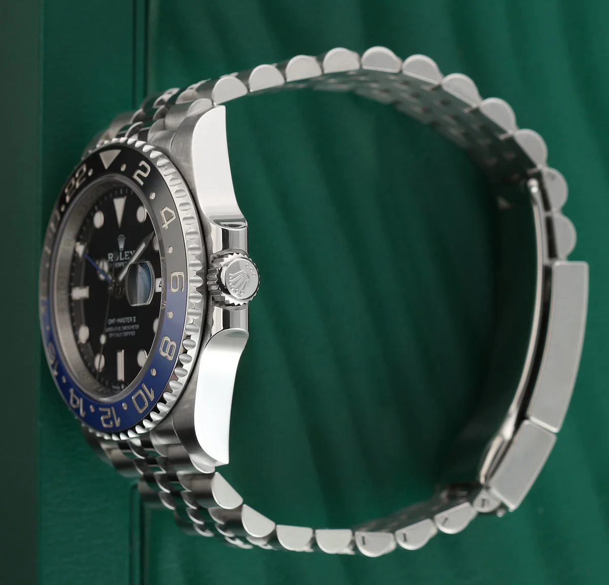 Three-quarter view showing how the Jubilee bracelet meets the case. The five-link architecture is visible in the rows of links.