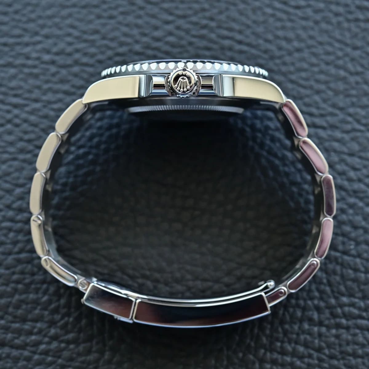 Crown side profile: Triplock crown, crown guards, and caseback edge