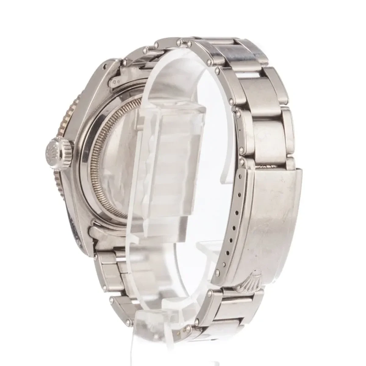 Bezel macro: the knurled edge, red luminous pip at 12 o'clock, and the fine graduation marks on the aluminum insert