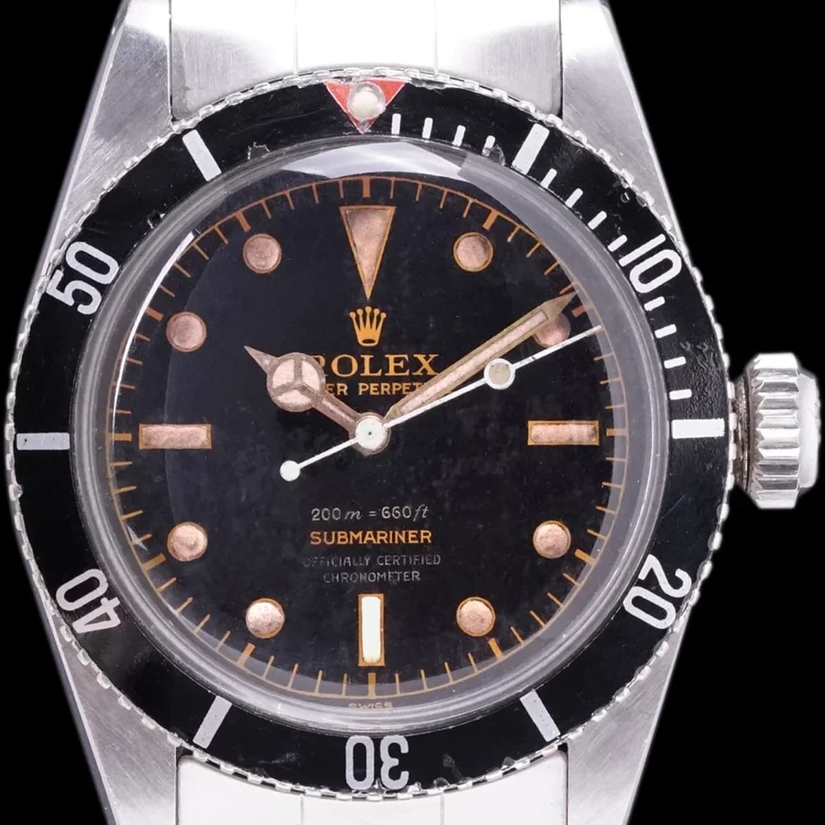 Full view with tropical gilt dial: the riveted Oyster bracelet, small red triangle, and the distinctive proportions of a 1950s Submariner