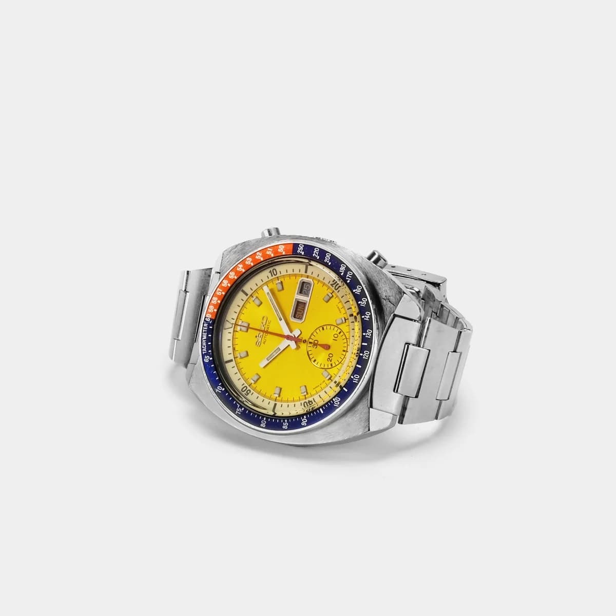 The Seiko 6139-6005 Pogue. Yellow sunburst dial with the iconic Pepsi tachymeter bezel.