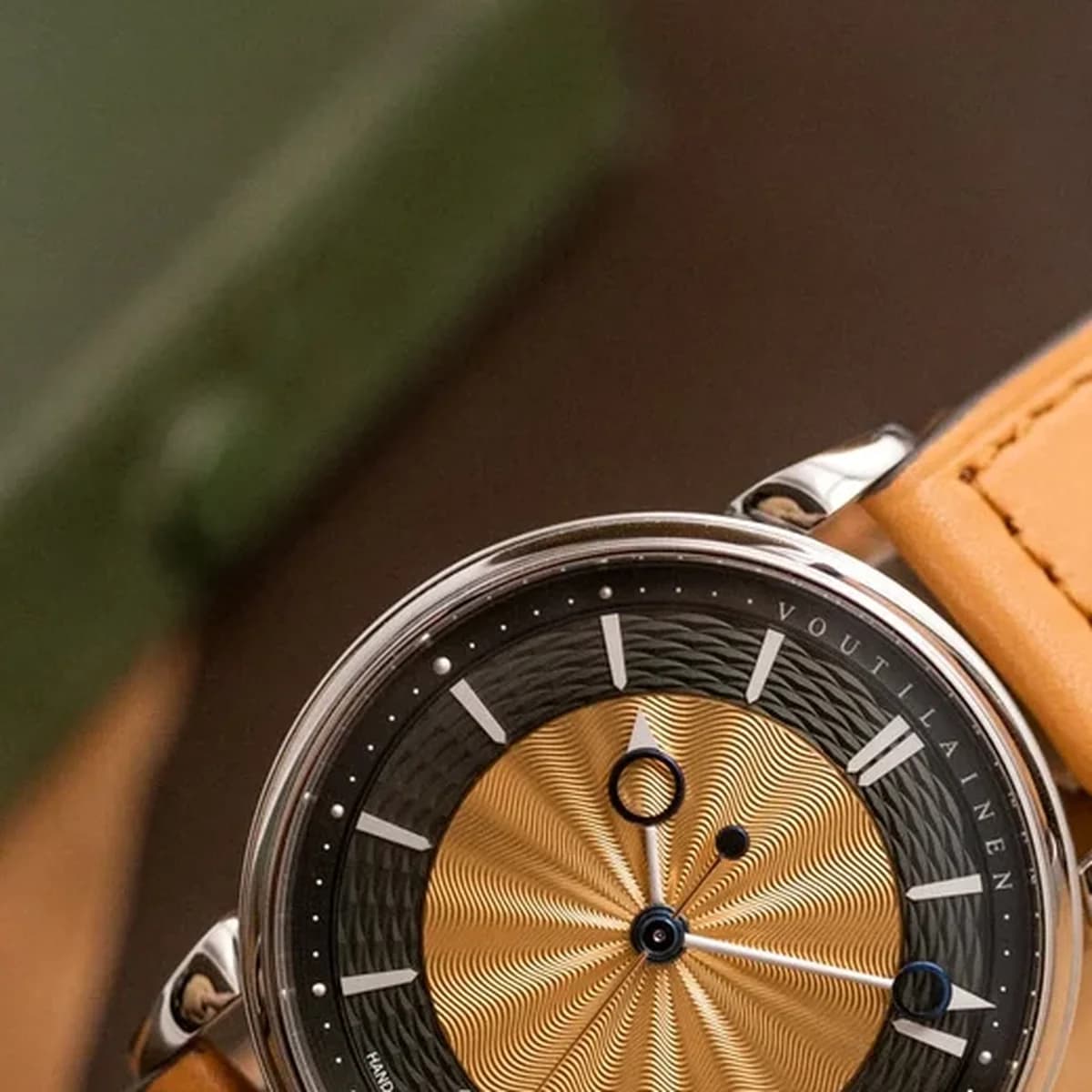 Voutilainen 28SC on cushion with gold sunburst guilloche center and dark wave outer ring